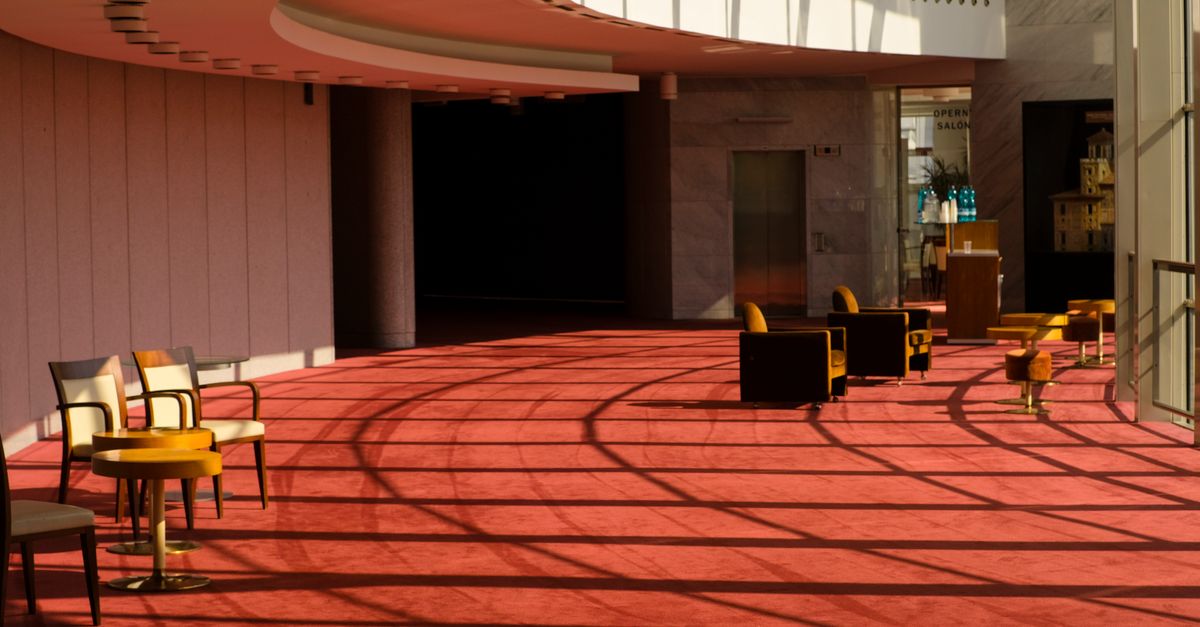 Sunlight casts shadows in a modern theater lobby in Bratislava, Slovakia.
